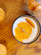 Joyful Spice with Cinnamon Orange Clove: A glass of creamy drink topped with orange slices.
