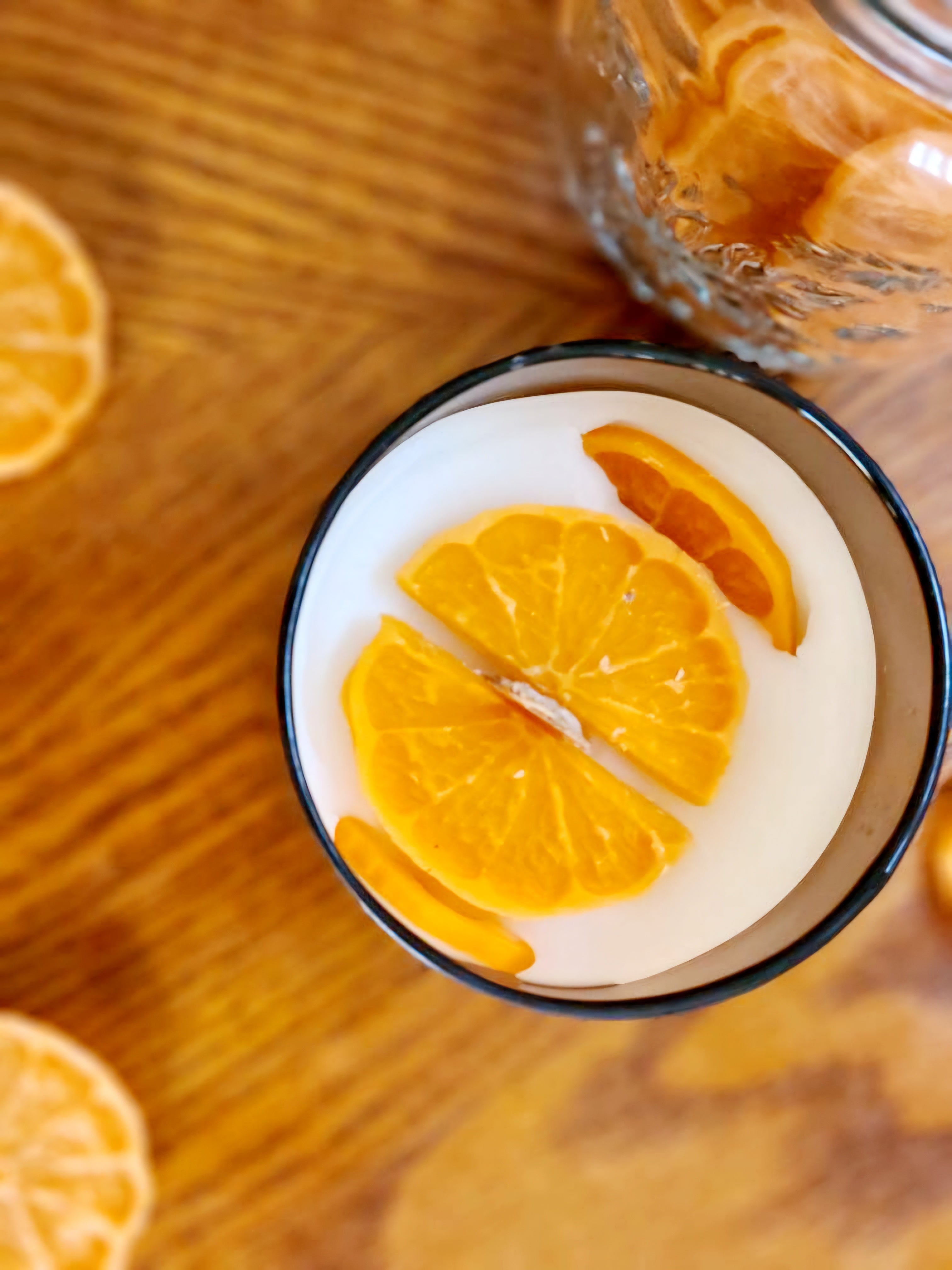 Joyful Spice with Cinnamon Orange Clove: A glass of creamy drink topped with orange slices.